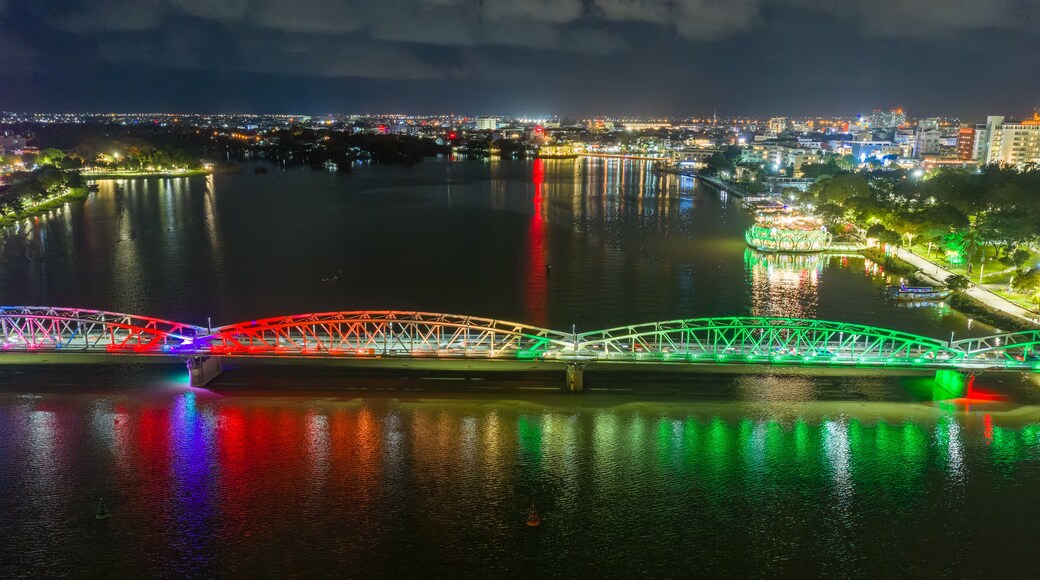 Panoramic view of Truong Tien Bridge in Hue City at night. Bridge illuminated all over with blurry reflection on. Travel and landscape concept