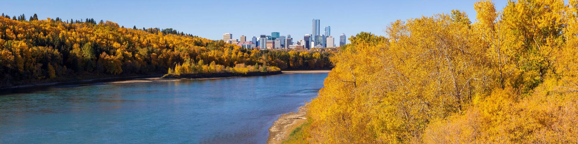 View of the Downtown Edmonton skyline and autumn colours of the river valley along the North Saskatchewan River; Edmonton, Alberta, Canada