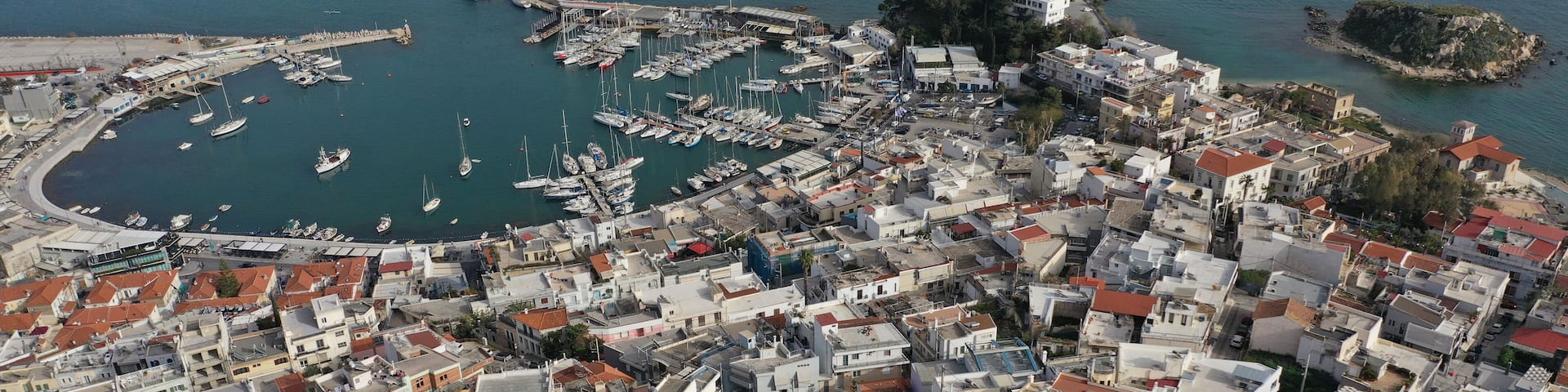 Aerial drone photo of famous ancient Greek architecture Municipal Theatre of Veakio built uphill with views to famous round port of Mikrolimano and city of Piraeus, Attica, Greece