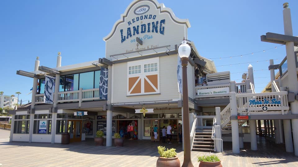 A waterfront building with a sign reading "Redondo Landing" and "More to Sea."