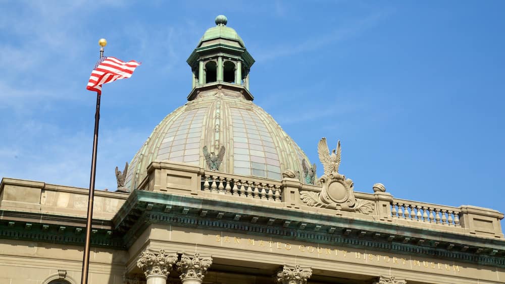 The San Mateo County History Museum with a large dome, an American flag, and ornate architectural details.