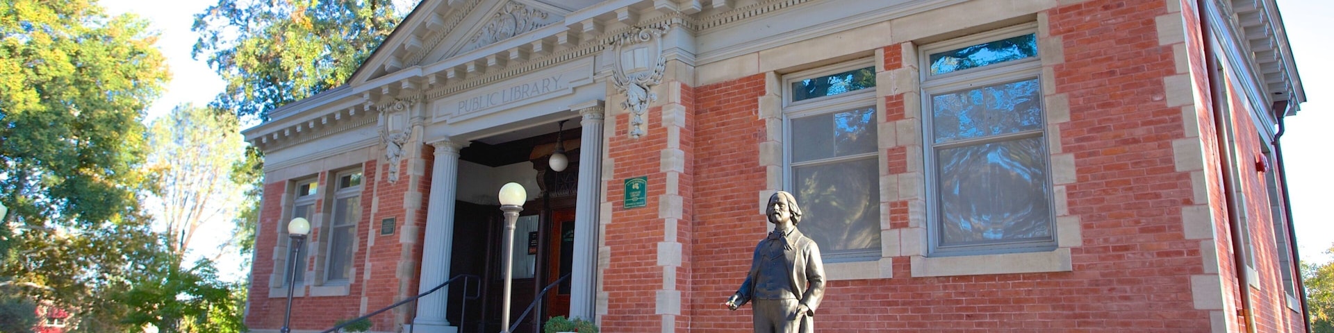 A brick building with a statue in front, labeled "Public Library."
