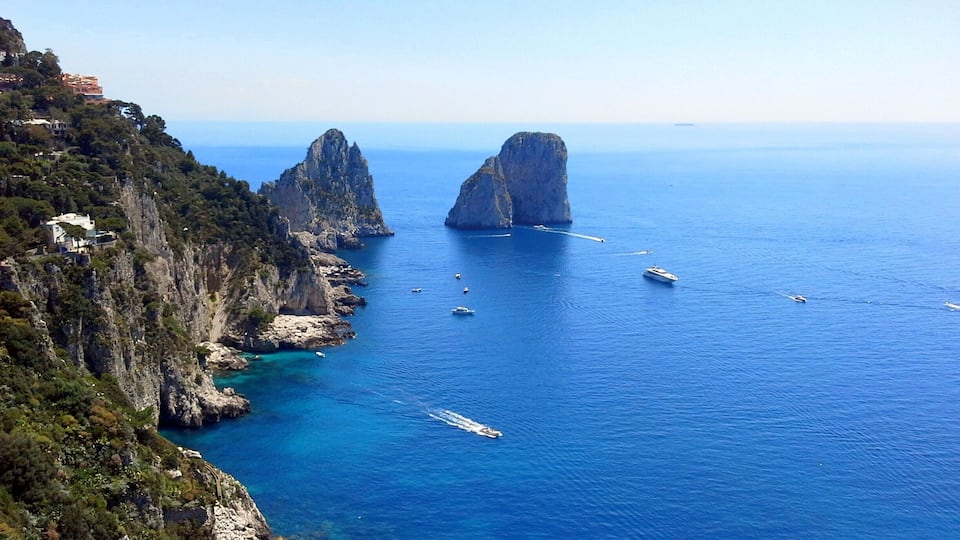 Faraglione - Stella, di Mezzo and di Fuori: Capri's legendary trio of sea giants. One of the first images to come to mind will, no doubt, be that of the Faraglioni: the three spurs of rock which rise up out of the sea, within meters of the island's Southern coast. The rocks have each been given a name: the first, still attached to the land, is called Stella, the second, separated from the first block by a stretch of sea; Faraglione di Mezzo and the third, Faraglione di Fuori or Scopolo, meaning the head or promontory stretching into the sea. The Scopolo sea stack provides the unique habitat for the Podarcis sicula coerulea. The rock is, in fact, the only place in the world where you can find this lizard, the blue color of which is said to be the result of the amphibian's vicinity to the sea and sky. The average height of the Faraglioni is 100 meters. The Faraglione di Mezzo is characterized by a central cavity, large enough to allow for the passage of a small boat.
#blue #BestOf5