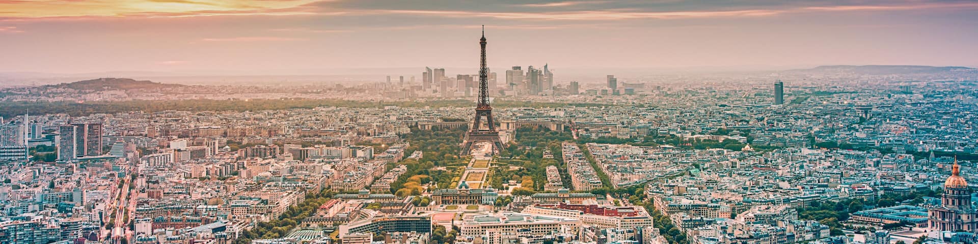 aerial view over Paris at sunset with iconic Eiffel tower