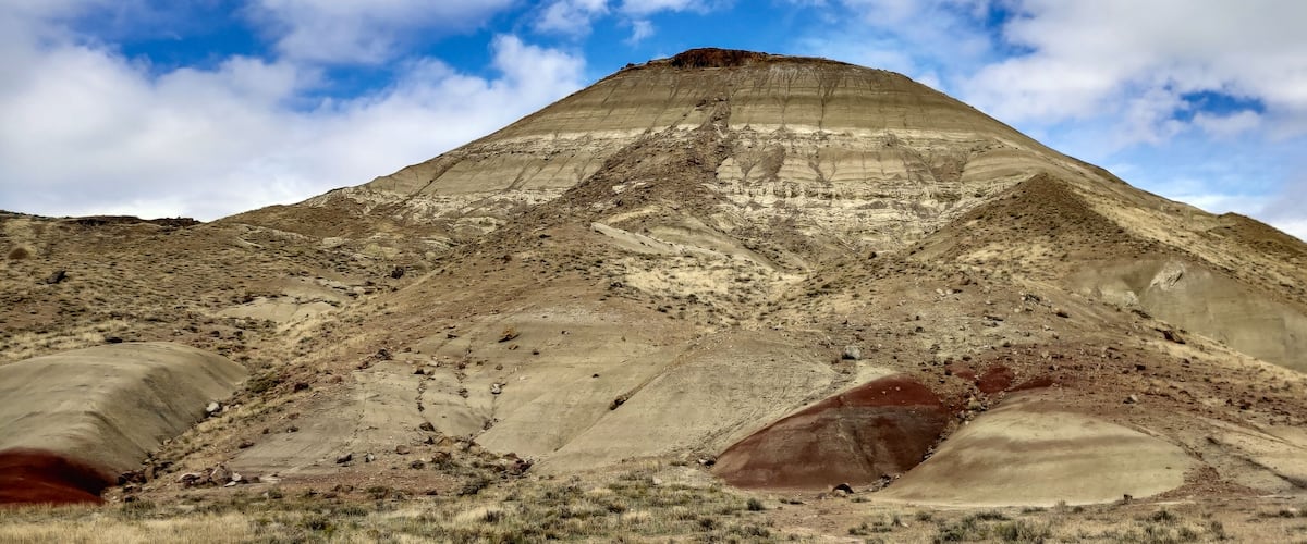 A large, layered mountain with distinct geological formations.