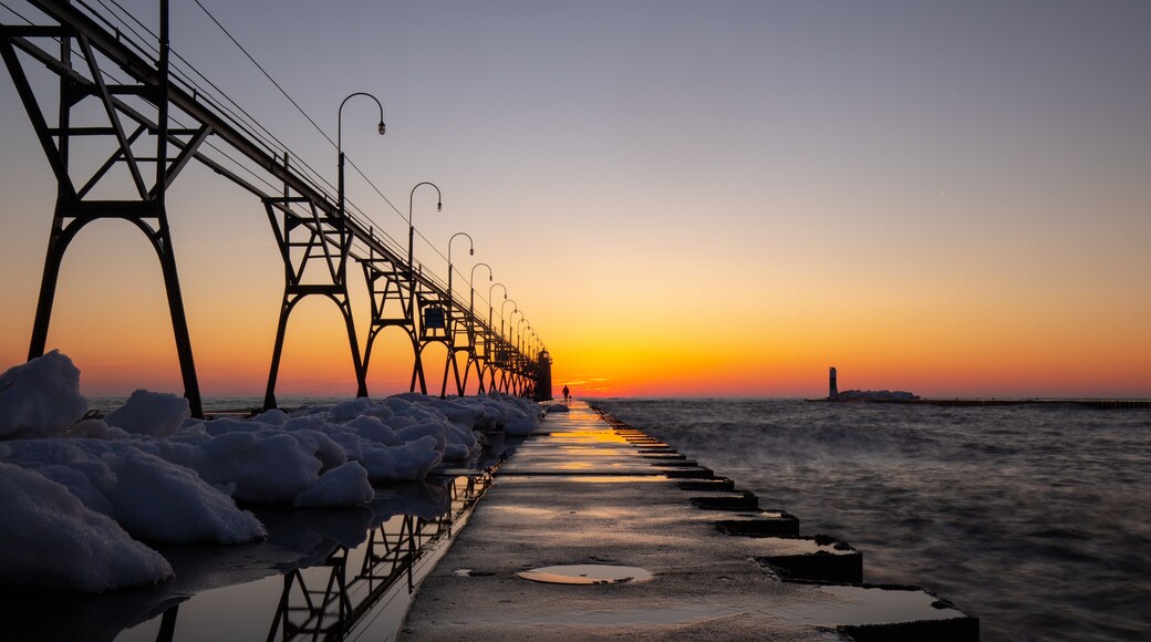 Lighthouse and lake side trail at beautiful sunset at South Haven Lake Michigan