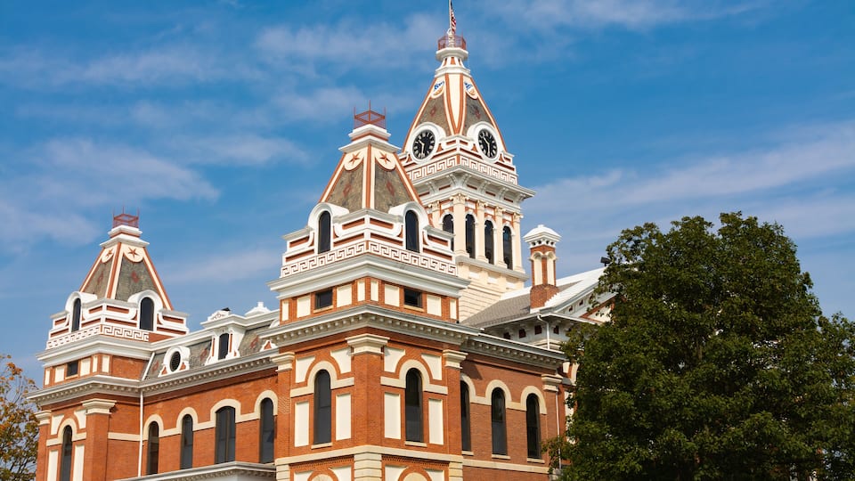 A historic building with ornate architecture, including a clock tower and decorative elements.