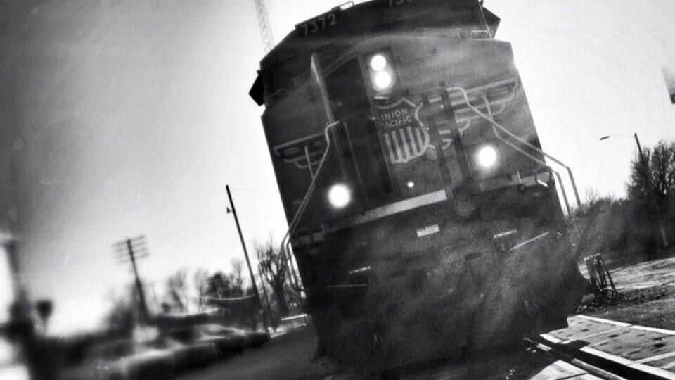 A train on tracks with a number 1372 on the front.