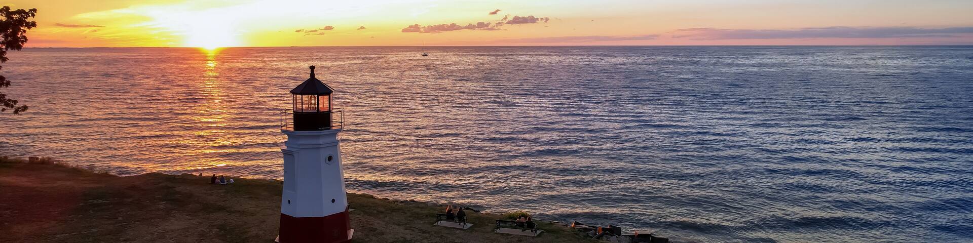 Historic Vermilion Lighthouse at harbor view state park in Vermilion city Ohio under evening light.