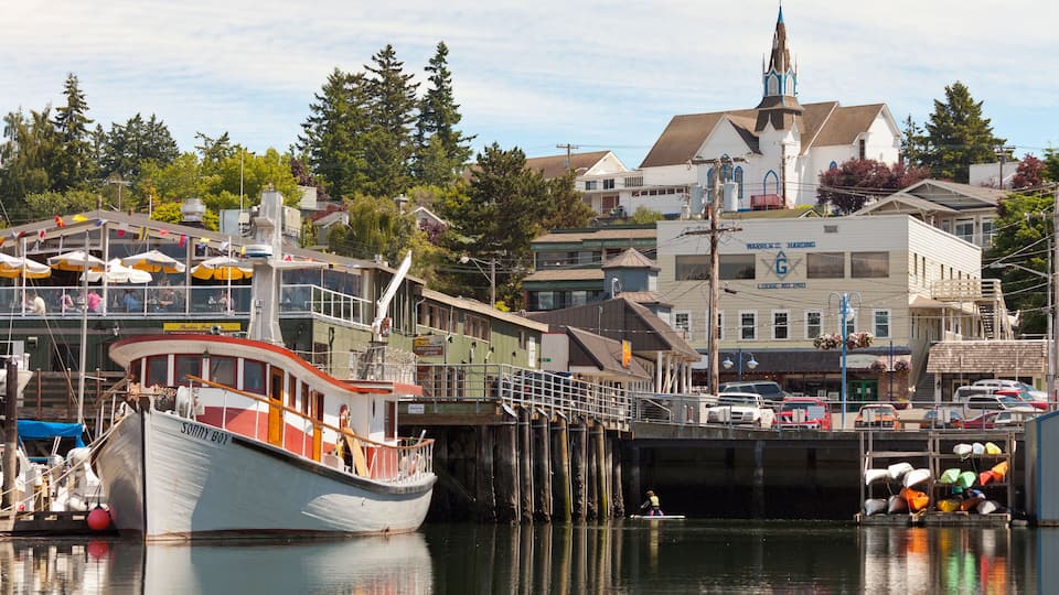 A harbor with boats, a church, and buildings.