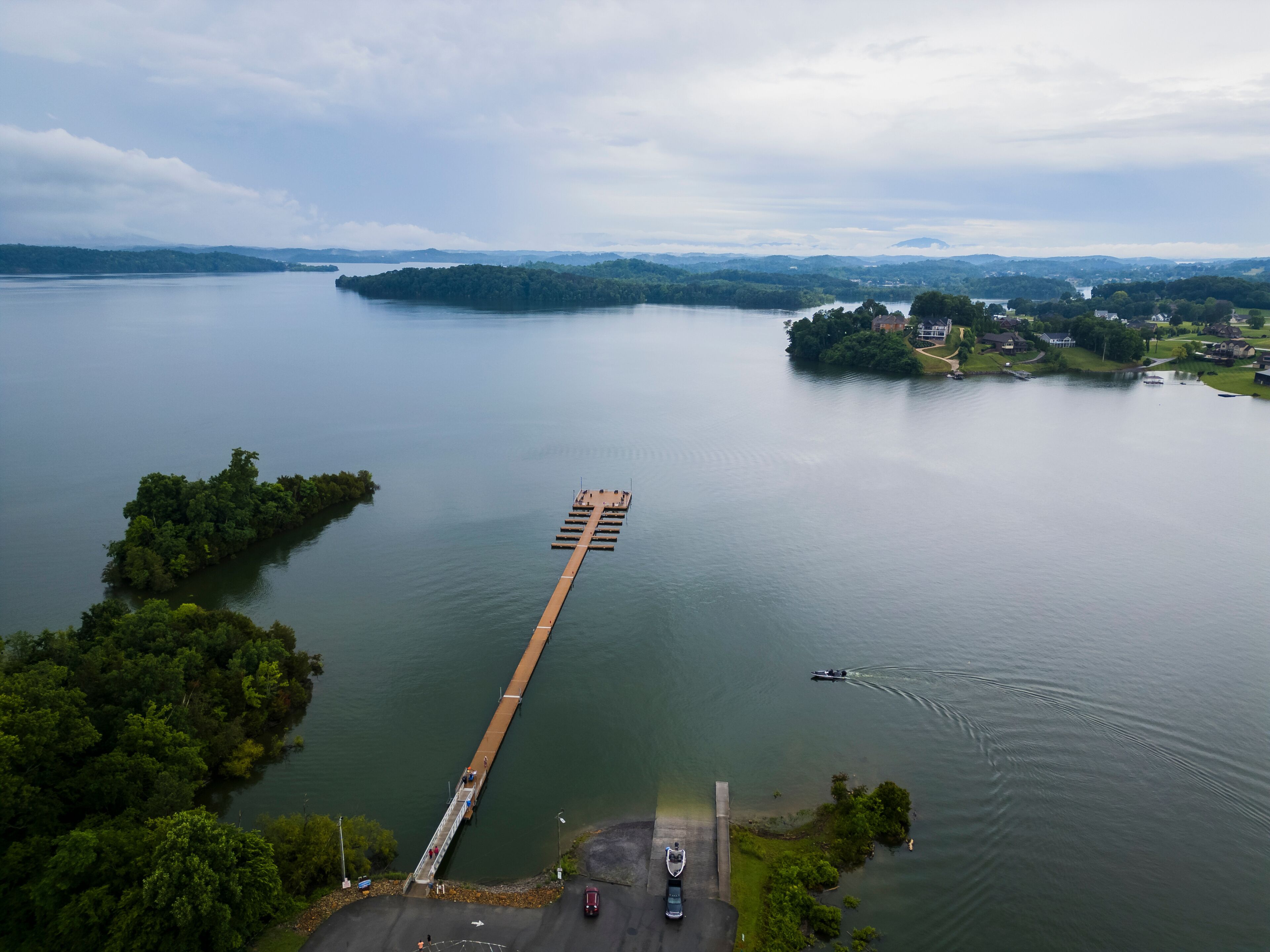 Aerial view of serene lake with pier, jetty, and bridge, Dandridge, Tennessee, United States.