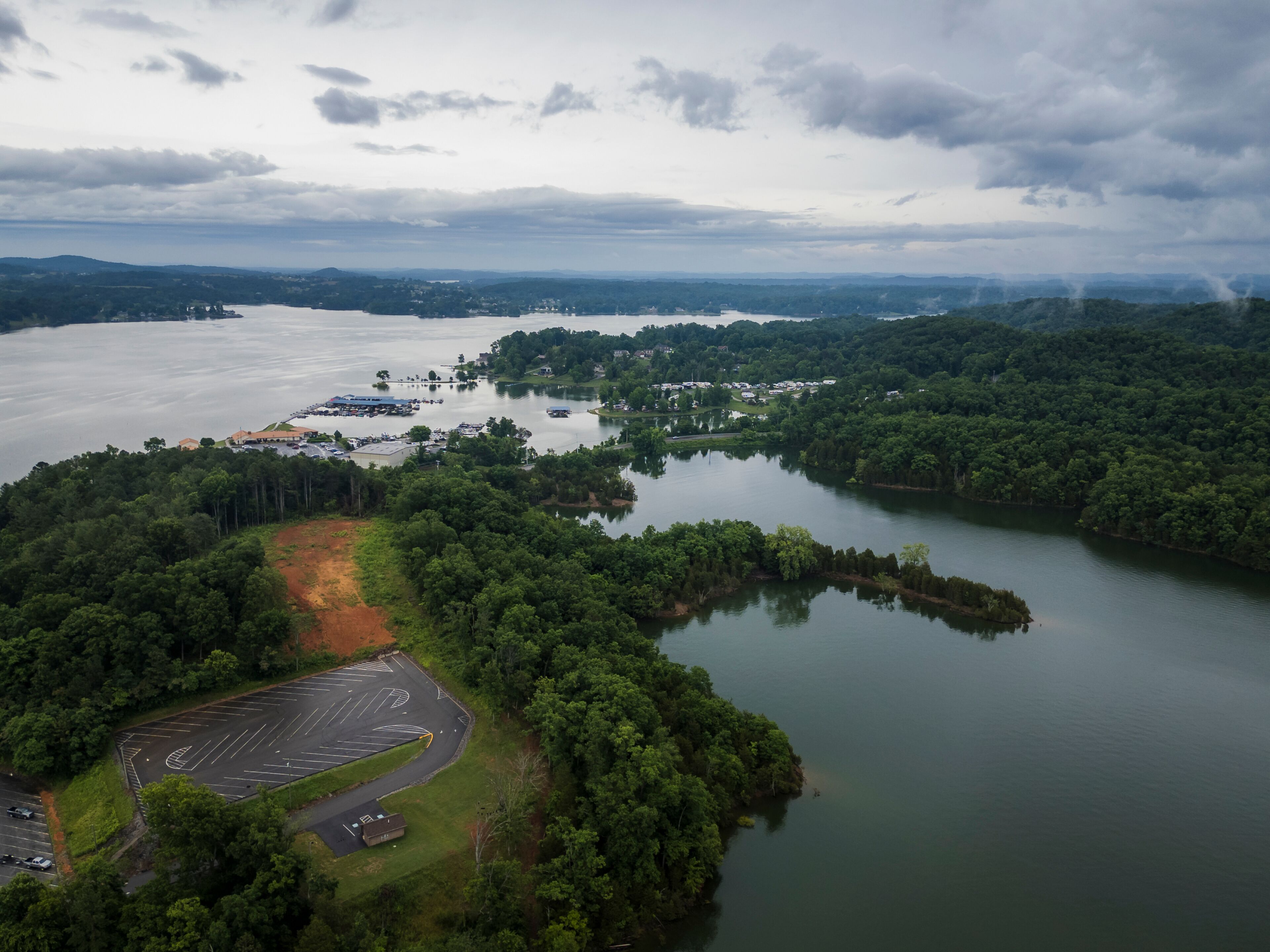 Aerial view of serene lake surrounded by lush forest and trees, Dandridge, Tennessee, United States.