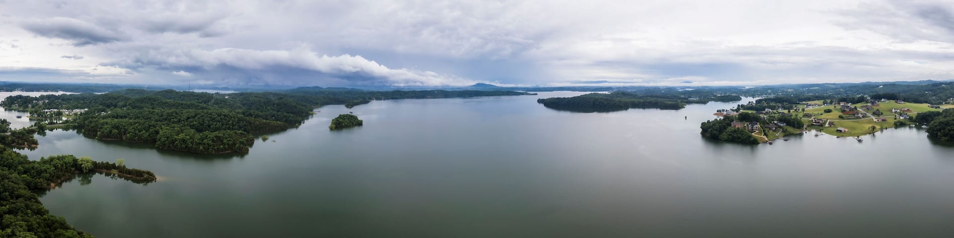 Aerial view of serene lake with forested islands and cloudy sky, Dandridge, Tennessee, United States.