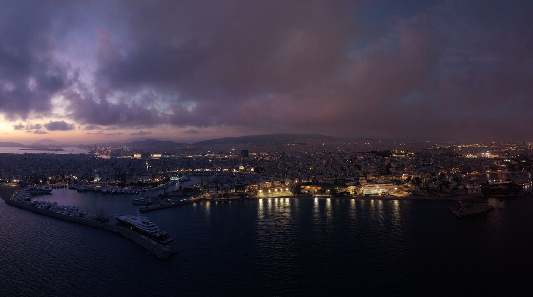 Aerial drone night panoramic shot of iconic round port and Marina of Zea or Passalimani at dusk with beautiful colours, Piraeus, Attica, Greece