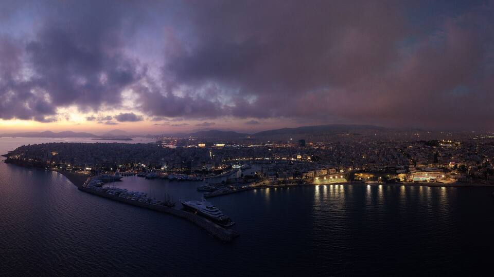 Aerial drone night panoramic shot of iconic round port and Marina of Zea or Passalimani at dusk with beautiful colours, Piraeus, Attica, Greece