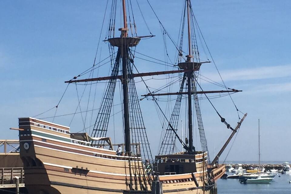 Een groot zeilschip in de haven, met andere boten in de buurt.