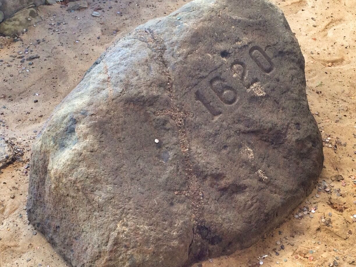 A large rock with the inscription "1820" on it.