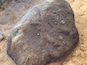 A large rock with the inscription "1820" on it.