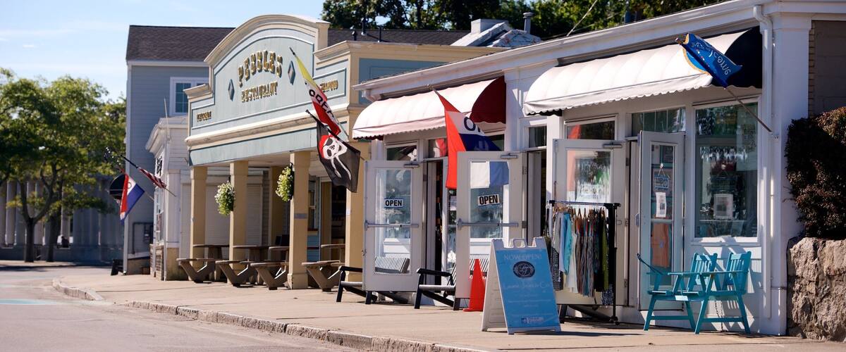 A street with a restaurant named "Pebbles Restaurant" and a nearby clothing store.