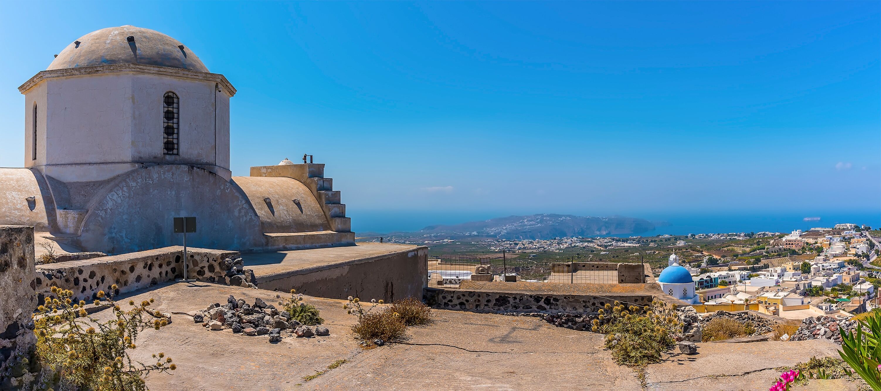 A panorama view across the castle ruins in Pyrgos, Santorini in summertime
