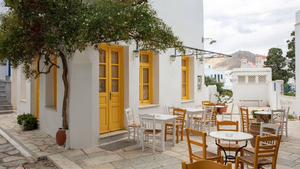 Greece. Tinos island Cyclades. Outdoors traditional cafe with yellow windows at Pyrgos village