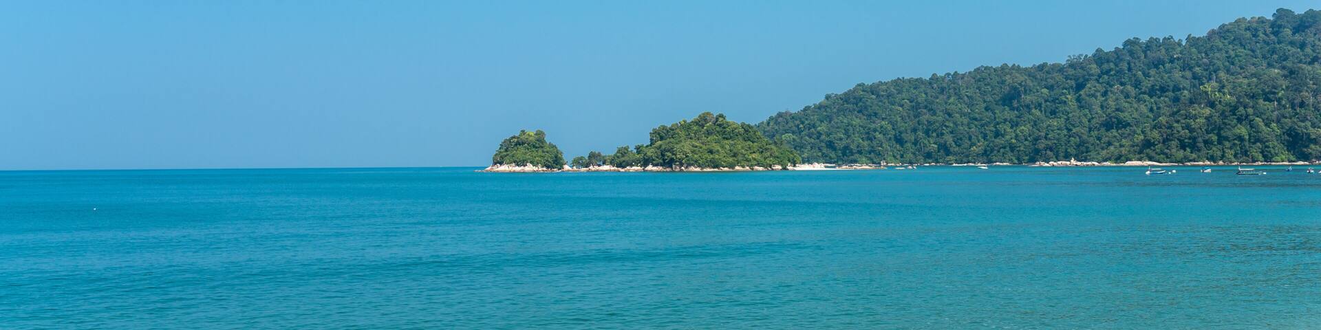 The island of Pangkor with the beach of the tourist village Teluk Nipah and the small isle of Giam in the Malaysian state of Perak at the west coast of the peninsular