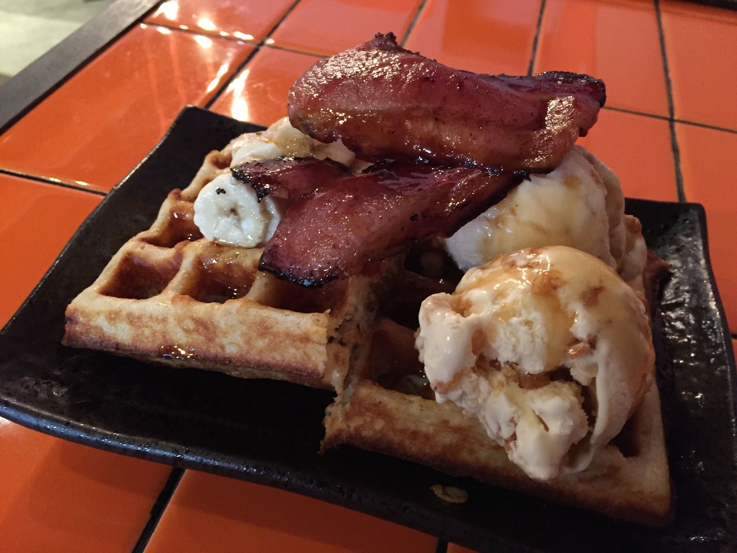 One of my favourites here. Waffles with ice cream and bacon :) Wash it down with a cup of #flatwhite 