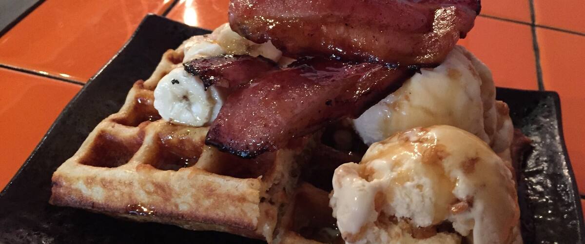 One of my favourites here. Waffles with ice cream and bacon :) Wash it down with a cup of #flatwhite
