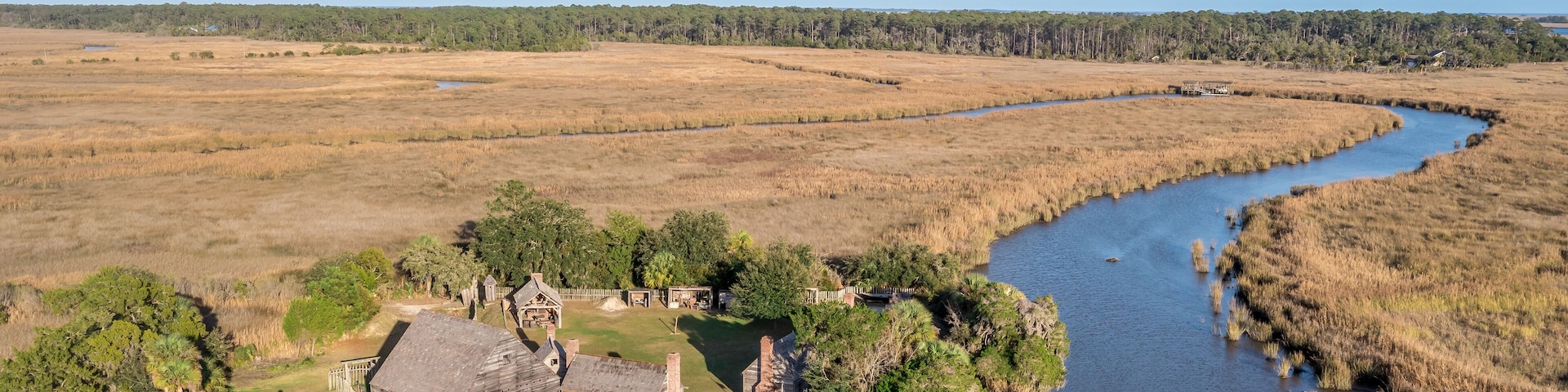 Aerial view of Fort King George historic site, oldest English fort on the Georgia coast from the 17th century with wooden palisade, gun ports for cannons blue cloudy sky near Darien Georgia USA