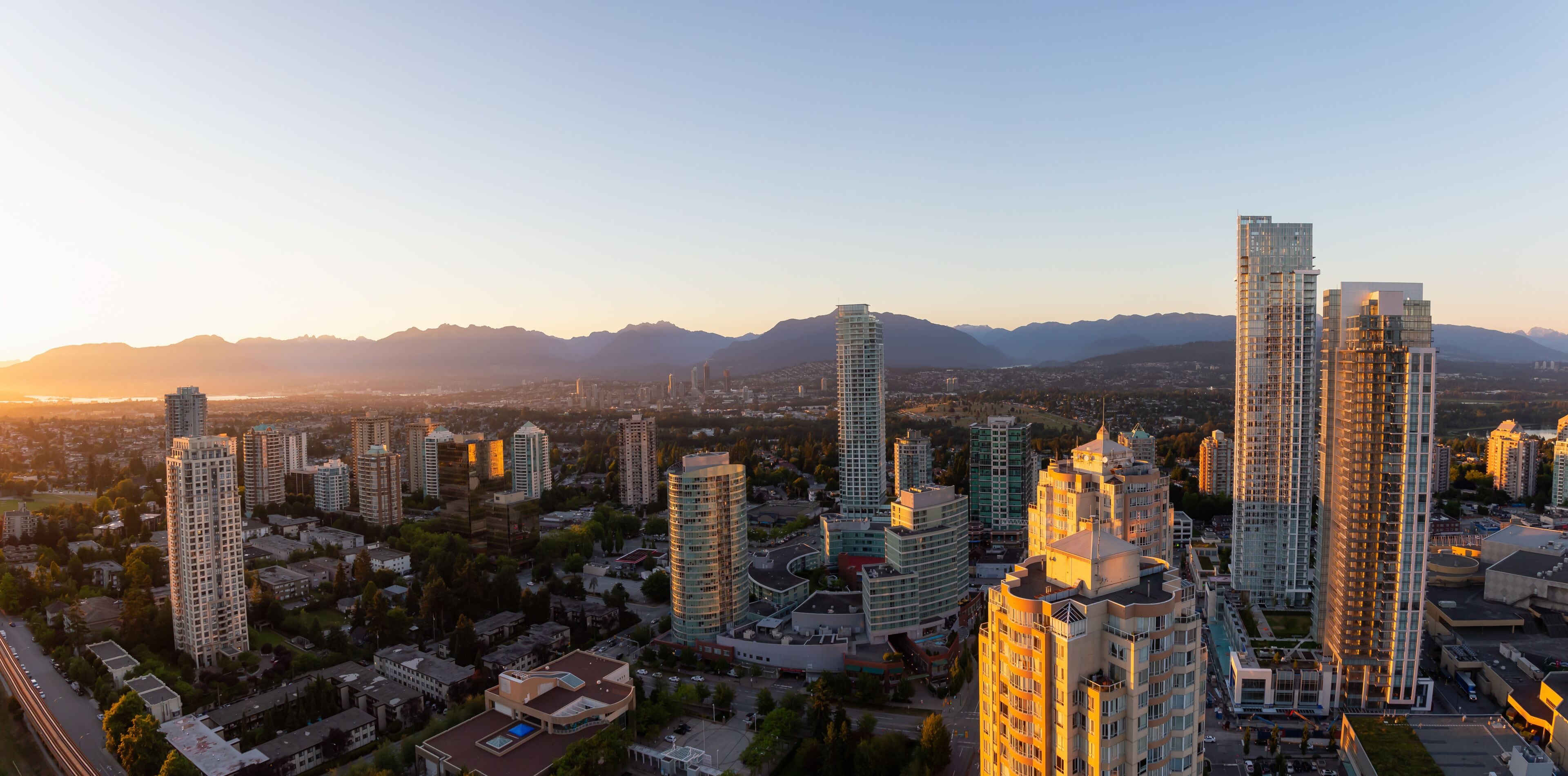 Aerial view of a modern city during a vibrant sunset. Taken in Metrotown, Burnaby, Vancouver, BC, Canada.