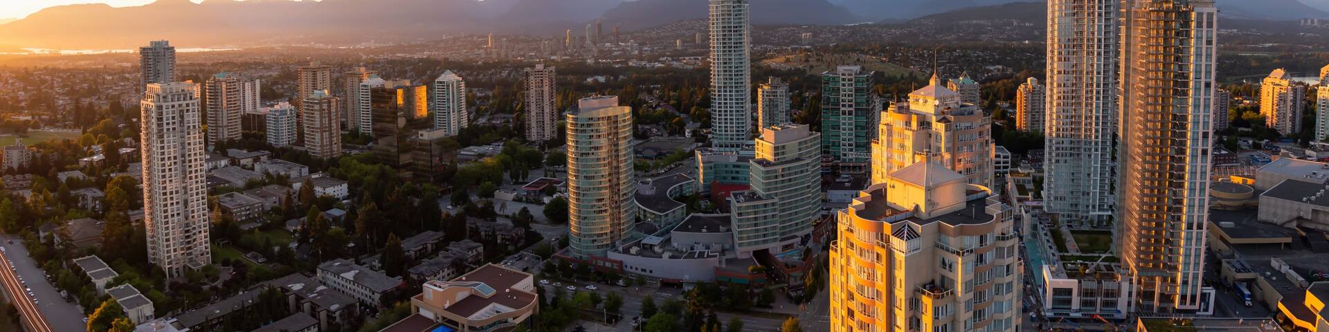 Aerial view of a modern city during a vibrant sunset. Taken in Metrotown, Burnaby, Vancouver, BC, Canada.
