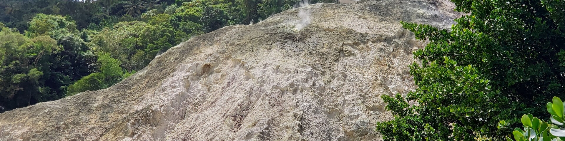 At the top of the mountain you can head to Sulphur Springs and enjoy a relaxing volcanic mud bath. I had a pretty bad sunburn and it took the sting right out and leaves you feeling super soft. First you dip into the hot water, then they paint you with the mineral rich mud, let it dry, then wash it off in the water. You will feel so good after it. While I was waiting for others to finish, I peeked around and found some nearby vents letting off their steam. It was this photo where it hit me that 'oh my goodness I'm standing next to volcanic vents' Haha. Freaked me out a bit but it was so beautiful watching them at the same time. The rocks were encrusted with minerals and occasionally you can see a whole bunch of vents just go off. I tried to catch it with my camera but just wasn't fast enough. You can also hike on the volcano or drive. It's the world's only drive in volcano. #SaintLucia #IslandLife #Carribean #WestIndies #Island