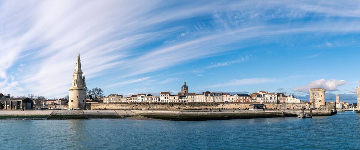 Panoramic view of the old harbor of La Rochelle with old towers on a sunny day