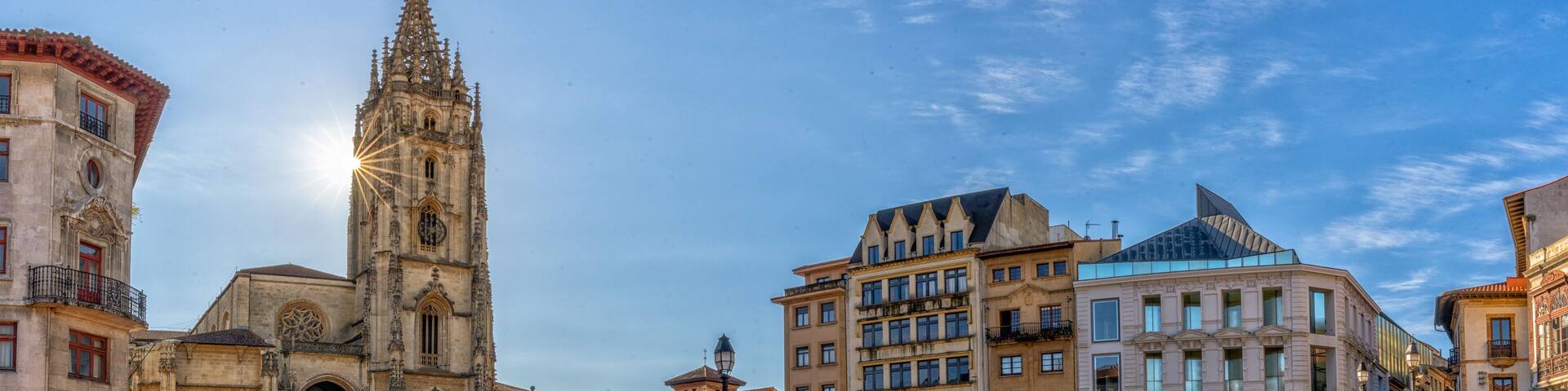 panorama view of the San Salvador Cathedral and square in the historic city center of Oviedo with a sunburst