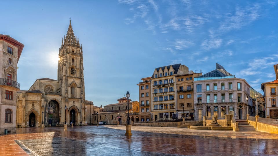 panorama view of the San Salvador Cathedral and square in the historic city center of Oviedo with a sunburst
