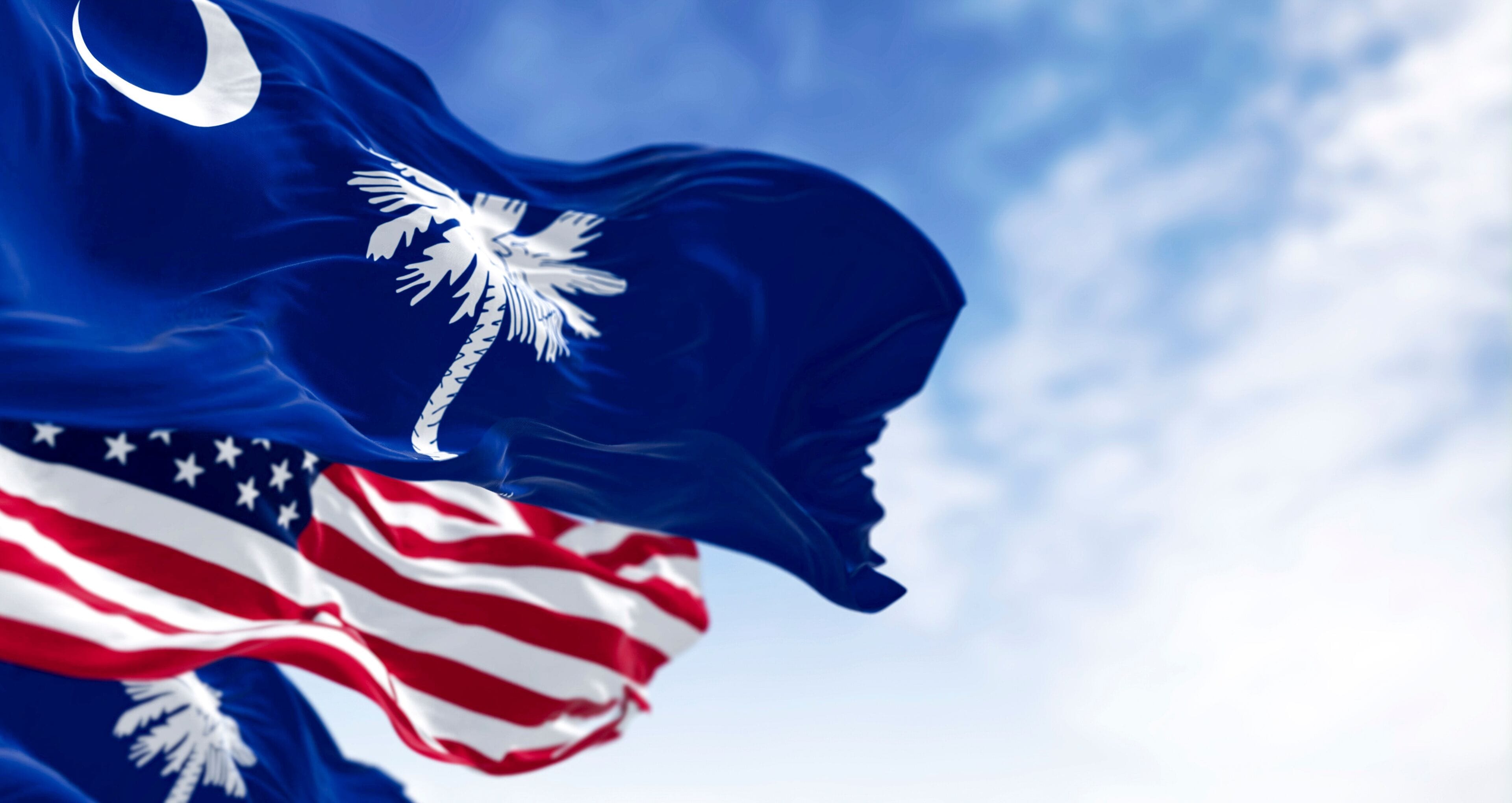 South Carolina state flags waving with the US flag