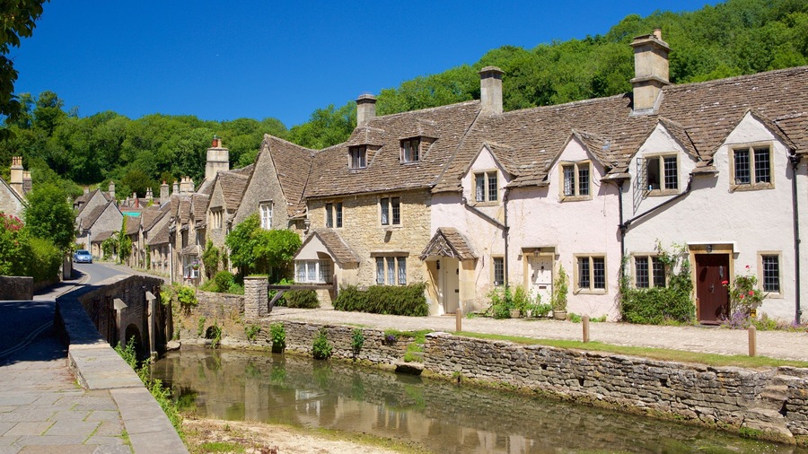 Castle Combe which includes a river or creek, a small town or village and a house