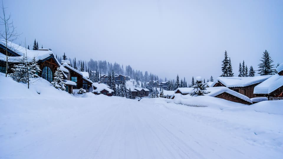 Snow covered houses and streets in a neighborhood of the alpine village of Sun Peaks in the Shuswap Highlands of central British Columbia, Canada