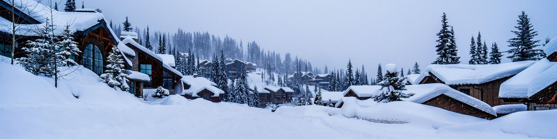 Snow covered houses and streets in a neighborhood of the alpine village of Sun Peaks in the Shuswap Highlands of central British Columbia, Canada