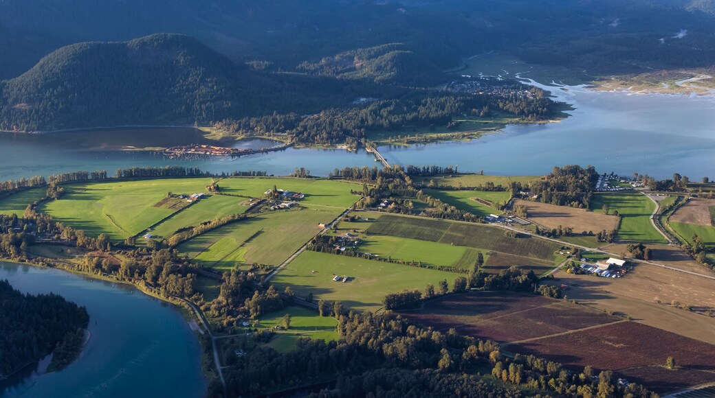 Aerial View of Fraser Valley with Canadian Nature Mountain Landscape Background. Harrison Mills near Chilliwack, British Columbia, Canada.