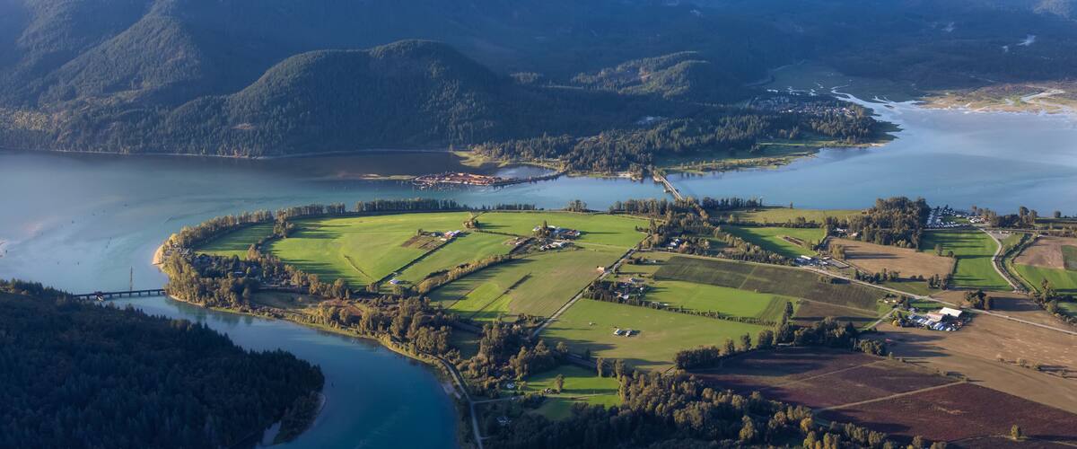 Aerial View of Fraser Valley with Canadian Nature Mountain Landscape Background. Harrison Mills near Chilliwack, British Columbia, Canada.