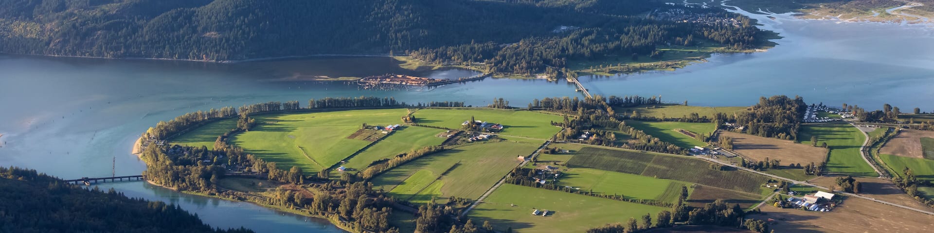 Aerial View of Fraser Valley with Canadian Nature Mountain Landscape Background. Harrison Mills near Chilliwack, British Columbia, Canada.
