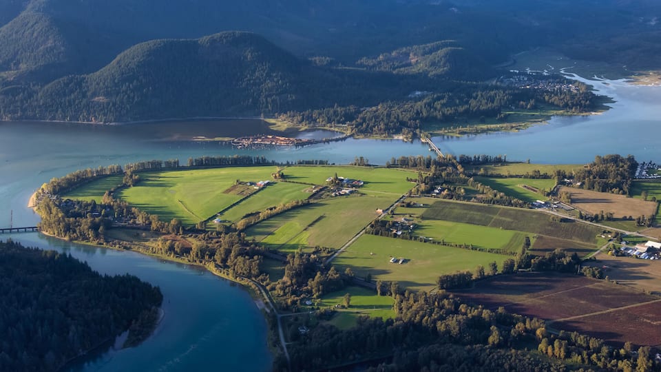 Aerial View of Fraser Valley with Canadian Nature Mountain Landscape Background. Harrison Mills near Chilliwack, British Columbia, Canada.