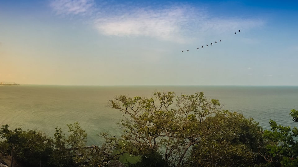 Hua Hin panorama view including sandy beach, green mountain, landscape, cityscape, cloudscape, blue sky scape and seascape in Hua Hin beach, Prachuab Khiri Khan, Thailand.