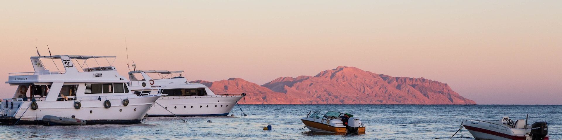 Sunset at Sharks Bay, Red Sea and motor yachts, Sharm el Sheikh, Egypt
