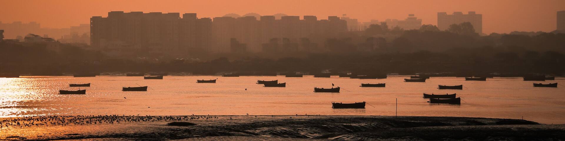 Panoramic silhouette of surat city while sun rising near ONGC bridge