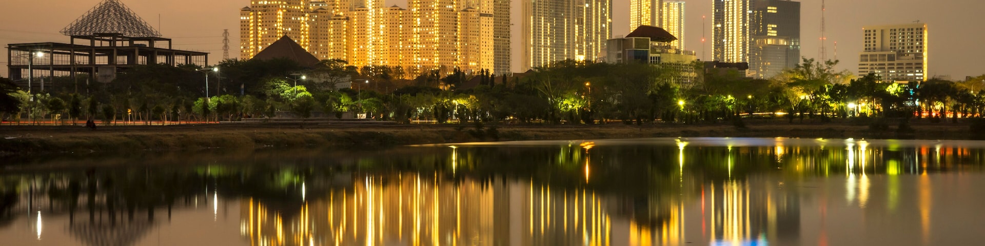 Golden hour city skyline with reflection of building after sunset in west Surabaya, Surabaya city, Indonesia