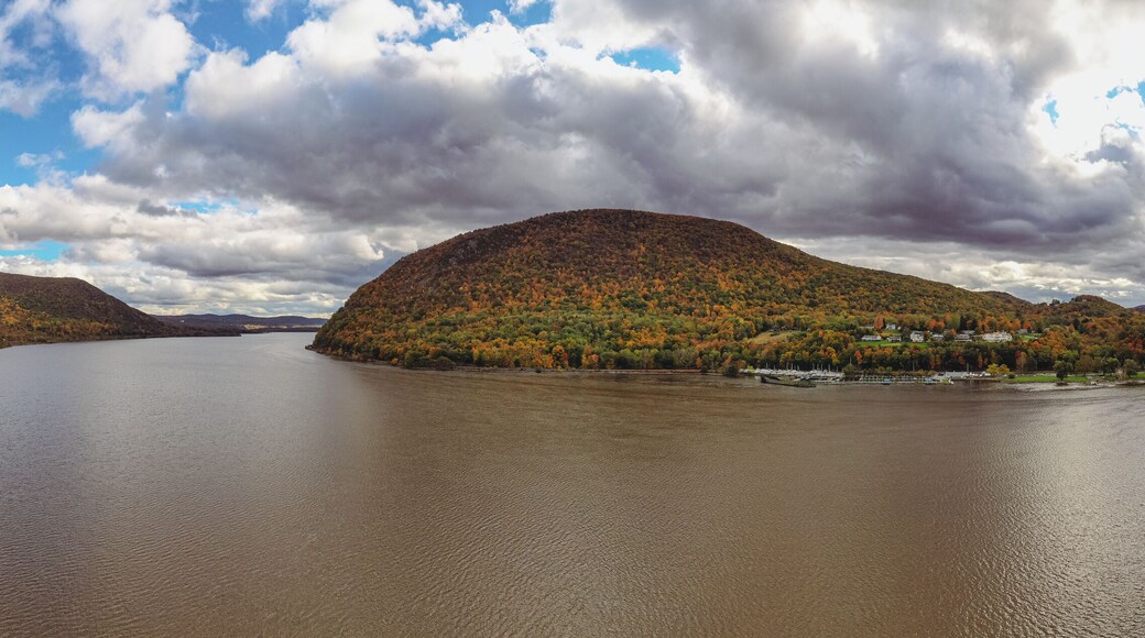 Panoramic view of the Hudson River with autumnal foliage around the mountains at Highland Falls