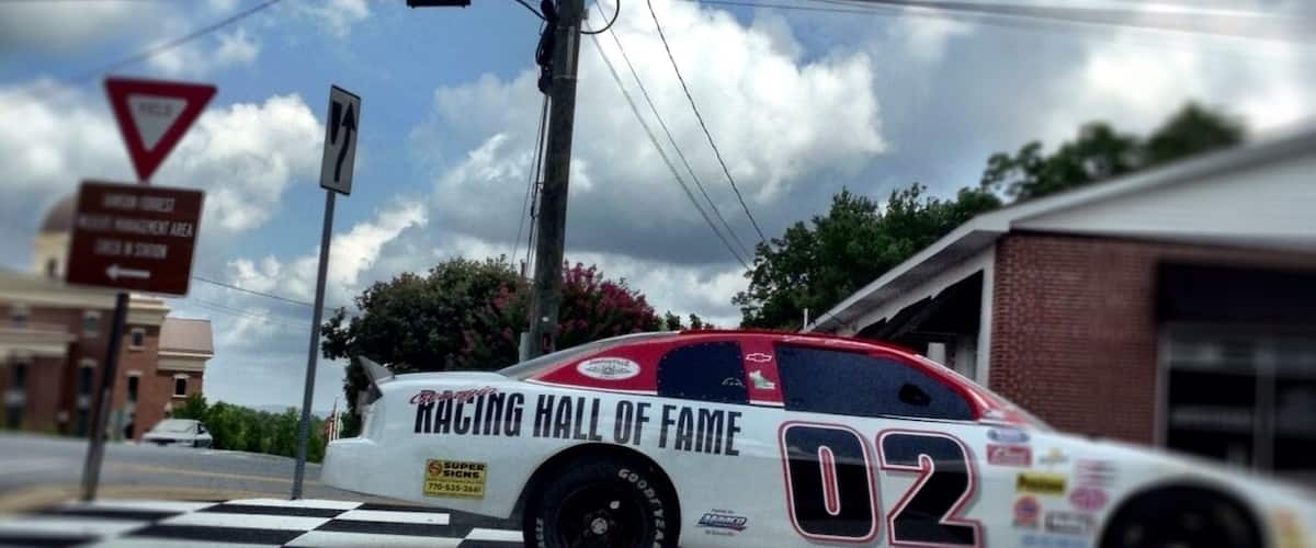 The car that doubles as a sign pointing you towards the Georgia Racing Hall of Fame it is very unique because you do not expect something as unique as a racing hall of fame in a small town.