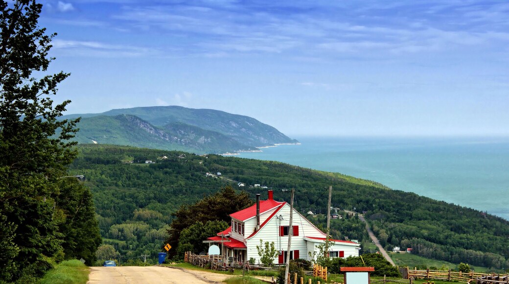 Red house on top of the Mountain and Landscape of La Malbaie Quebec Canada in Background